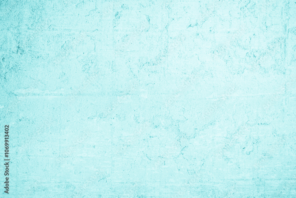 Obraz premium Grungy blue textured paper background with faded watercolor paint stains.