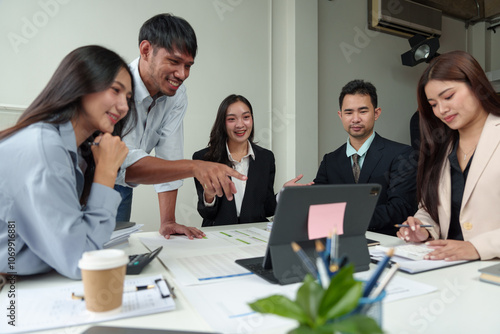 Financial analyst analyzes business finance reports on laptop and graph documents during corporate meeting discussions showing successful teamwork, business meeting ideas, marketing.