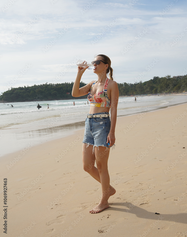 A young woman enjoying a beautiful day at the beach A young woman enjoying a beautiful day at the beach
