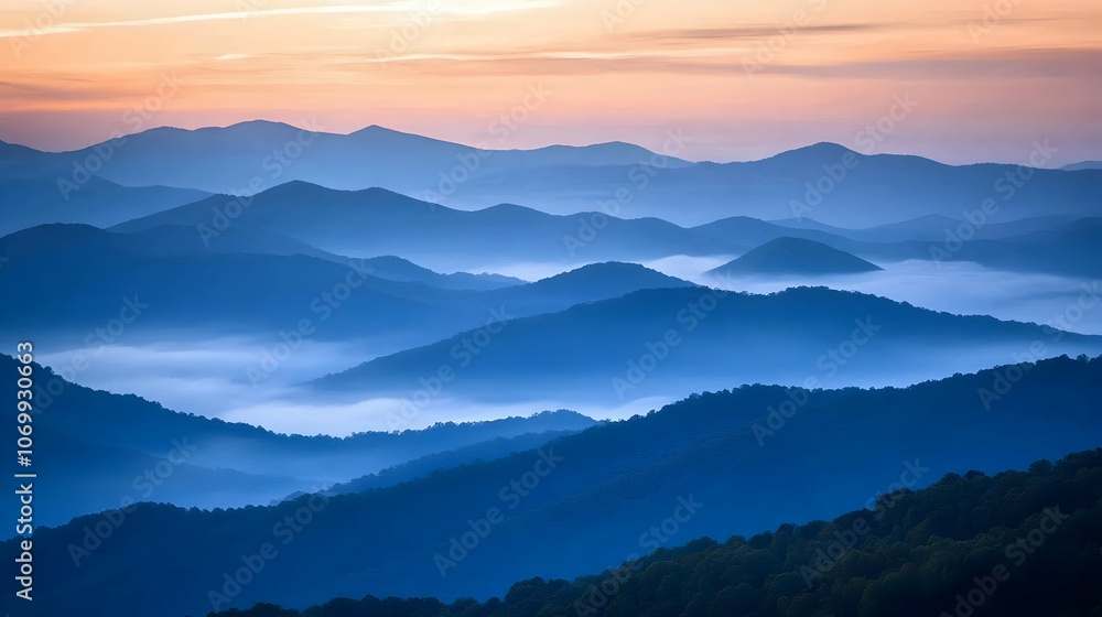 Serene mountain landscape with mist and a vibrant sky.