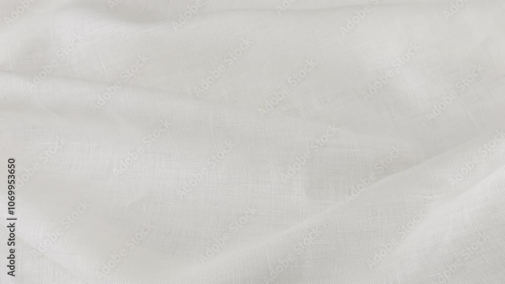 Soft folds of the white linen fabric rotates on the showcase. Top view of textile background. Theme design, fashion, tailoring of clothes. Soft folds of the white linen fabric rotates on the showcase. Top view of textile background. Theme design, fashion, tailoring of clothes.