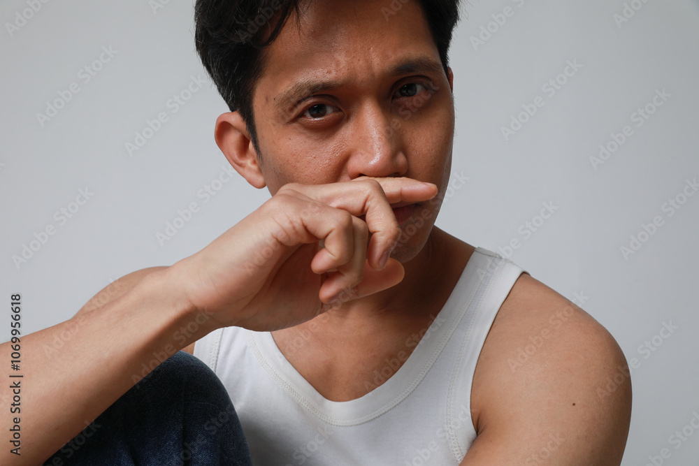 Close-up portrait of handsome asian man posing over white background looking at the camera. Close-up portrait of handsome asian man posing over white background looking at the camera.