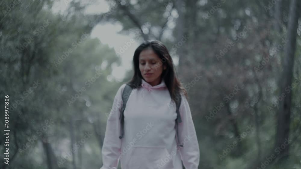 Woman walking and contemplating her natural surroundings. Woman walking and contemplating her natural surroundings.