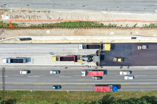 Drone View of Asphalt Laying Machine and Trucks During Road Paving Process
 photo