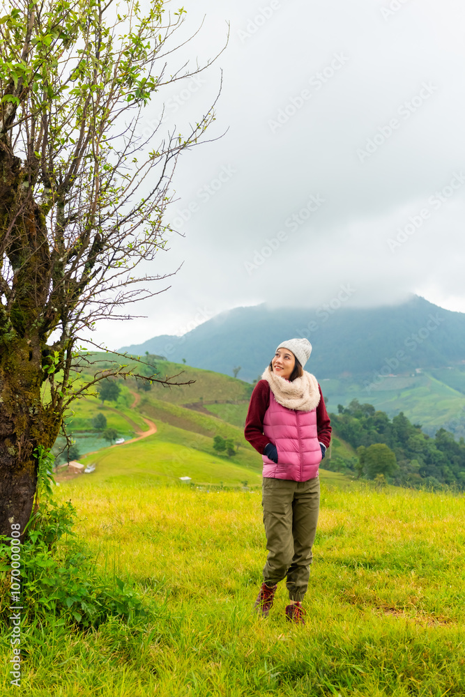 Happy Asian woman walking on mountain hill during camping on the mountain. Attractive girl enjoy outdoor active lifestyle travel nature hiking and camping at forest mountain on holiday vacation. Happy Asian woman walking on mountain hill during camping on the mountain. Attractive girl enjoy outdoor active lifestyle travel nature hiking and camping at forest mountain on holiday vacation.