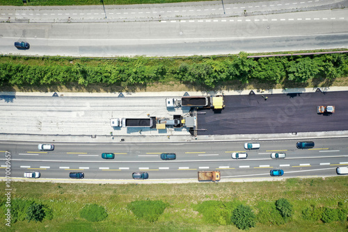 Drone View of Asphalt Laying Machine and Trucks During Road Paving Process
 photo