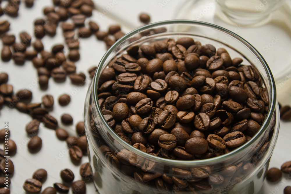 Jar with coffee beans on white table Jar with coffee beans on white table