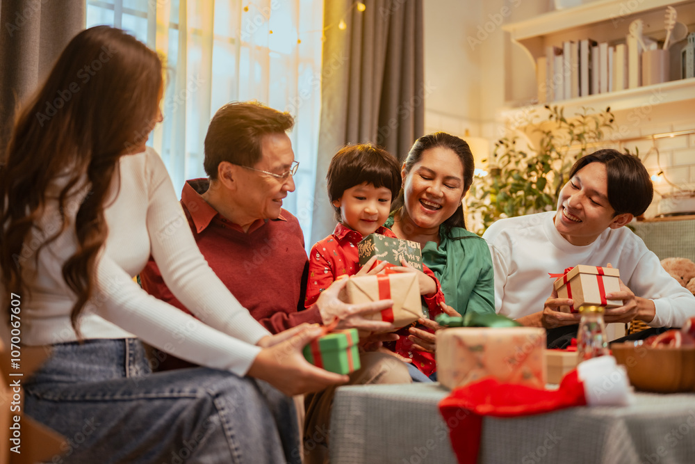 Fototapeta premium presents, parenthood, family, party, celebrate, xmas, celebration, gift, christmas, parents. A family of four is sitting on a couch, opening presents and laughing. Scene is joyful and festive.