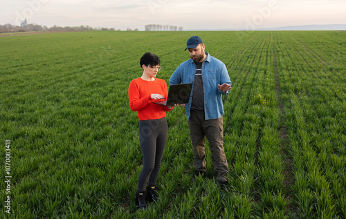 Farmer and agronomist in wheat field