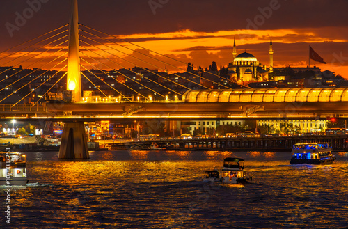 cityscape of Istanbul at night, Turkey, view to the Golden Horn Bay and architecture of city and a bridge for metro and Bosphorus shore against the sunset sky, a popular tourist destination photo