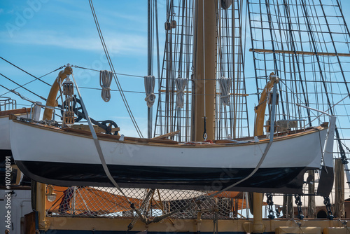 A vintage lifeboat, or dinghy, mounted on the side of a larger vessel, used for emergencies to allow crew and passengers to evacuate in case of an emergency at sea. Phuket, Thailand.