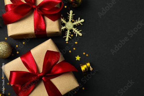 Beautiful gift boxes tied with bows and Christmas decorations on color background 