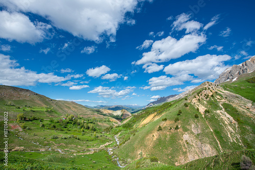 Green plains, snowy mountains. Blue sky and snowy mountains. Snowy mountains of Tunceli. Pülümür Valley, Buyer Mountain, Sarıgül Plateau, Buyer Waterfall.Munzur, Tunceli, Türkiye. 