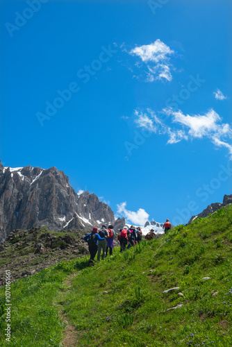 People walking on green land. Trekking and hiking in Tunceli mountains. Green mountains and plains of Tunceli. Pülümür Valley, Buyer Mountain, Sarıgül Plateau. Tunceli, Türkiye. photo