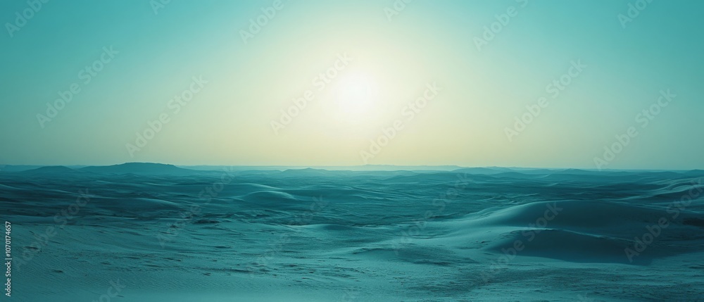 Obraz premium The serene desert landscape glows under a sunlit sky, casting soft shadows over the rolling dunes.