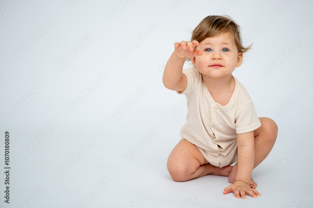 A baby boy crawls on a white isolated background with a place for text in light clothes. A small happy child, space for text A baby boy crawls on a white isolated background with a place for text in light clothes. A small happy child, space for text