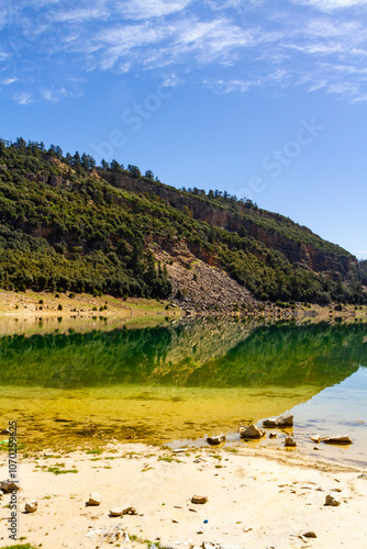 The beautiful crystal clear Aguelmame Sidi Ali Lake. Khenifra National Park, Middle Atlas Mountains, Morocco photo