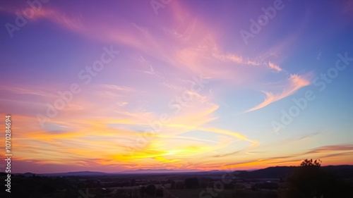 Serene Sky With Wispy Clouds And Warm Sunset Colors Over A Distant Silhouette Of Rolling Hills