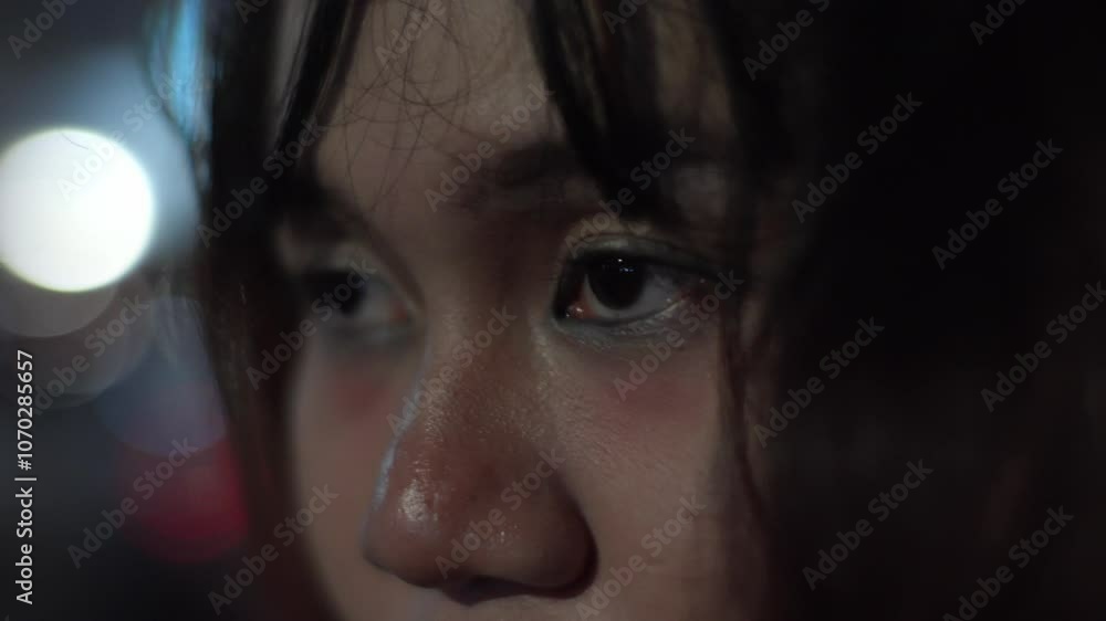 Close-up Of A Young Exhausted And Sad Asian Woman On A City Street At Night. Close-up Of A Young Exhausted And Sad Asian Woman On A City Street At Night.