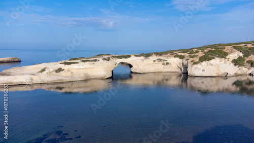 aerial view of the rock of S'Archittu di Santa Caterina in the province of Oristano, Sardinia, Italy photo