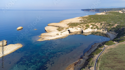 Limestone rock with arch, S`Archittu di Santa Caterina in Oristano Province, Sardinia, Italy photo