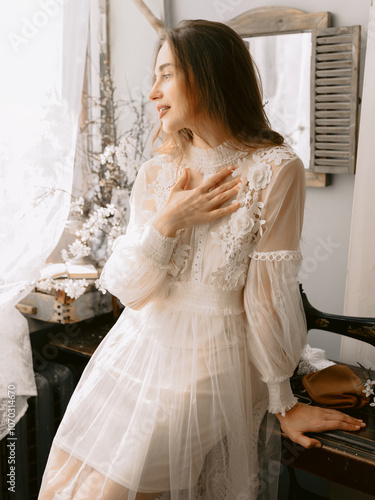 Attractive young woman wearing vintage style pastel dress indoor.