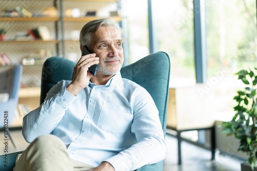 Businessman with smartphone having cellcall at office