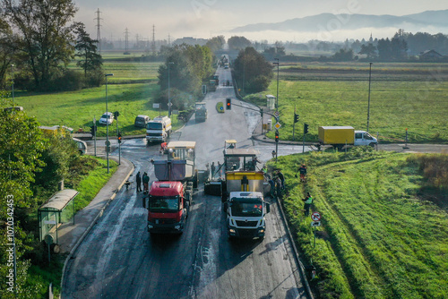 Wallpaper Mural Drone View of Asphalt Laying Process with Two Pavers, Compact Rollers, and Equipment at Road Junction with Traffic Lights and Scenic Field Background Torontodigital.ca
