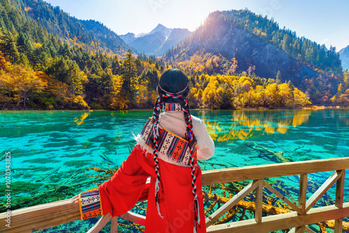 Tourist wearing traditional clothes at jiuzhaigou national park in autumn, Sichuan, China.