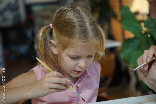  A young mother and her daughter enjoy a creative art session at home 