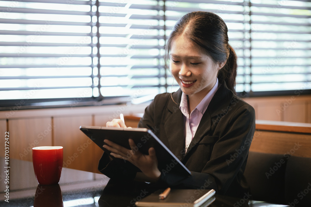Asian businesswoman relaxing in a modern office Asian businesswoman relaxing in a modern office