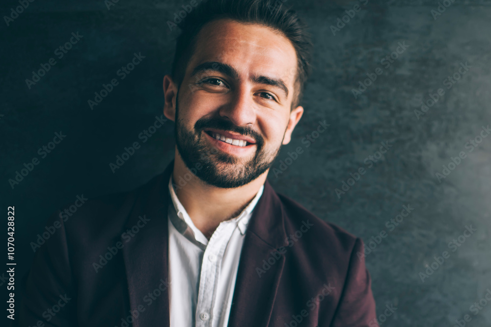 Prosperous caucasian businessman in formal outfit looking at camera dressed in stylish jacket standing with cellular on promotional background, portrait of happy millennial male entrepreneur Prosperous caucasian businessman in formal outfit looking at camera dressed in stylish jacket standing with cellular on promotional background, portrait of happy millennial male entrepreneur
