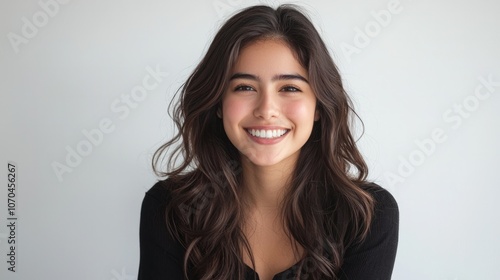 A young woman with a radiant smile showcasing her healthy hairstyle in a beauty salon against a bright white backdrop, 