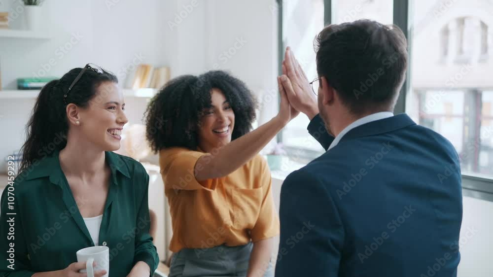 Video of business team celebrating good job while holding up their right hands on modern startup Video of business team celebrating good job while holding up their right hands on modern startup