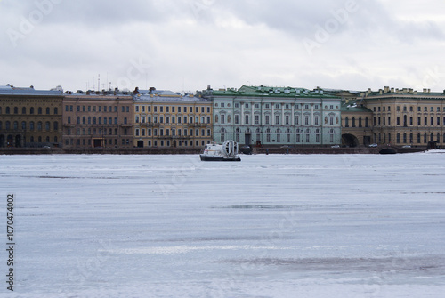 Frozen river in the city in winter, walks for tourists, recreation. City.