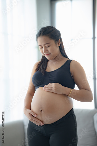 Pregnant asian woman holds hands on belly touching her baby caring about her health Beautiful happy pregnant woman tender mood photo of pregnancy. Free Download Pregnant asian woman holds hands on belly touching her baby caring about her health Beautiful happy pregnant woman tender mood photo of pregnancy. - GFXLoad