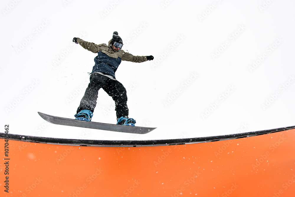Pro rider leaps into wallride, conquering slope challenges with skill. Pro rider leaps into wallride, conquering slope challenges with skill.