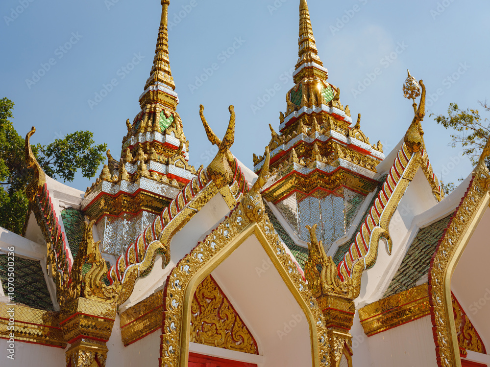 Fototapeta premium details of a small Modern Buddhist temple in Thailand, showcasing vibrant architecture and cultural heritage, with intricate details and spiritual atmosphere reflecting Thai tradition and design.