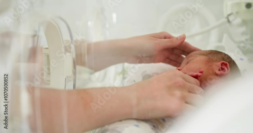 A tender moment of a fragile premature baby in an incubator, emphasizing the importance of neonatal care and love. Newborn in an Incubator Specialized Care for Premature Babies During Their Early Life