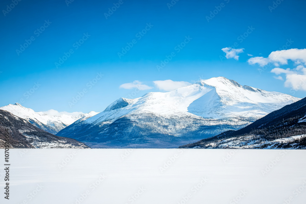 custom made wallpaper toronto digitalSnow-covered mountains and tranquil frozen lake under bright blue sky in winter landscape