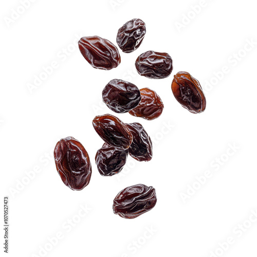 A cluster of dark, wrinkled raisins scattered irregularly, showcasing their textured surface and rich color. photo