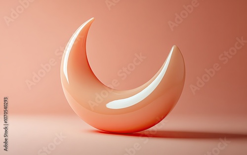 A smooth, abstract sculpture resembling a crescent moon, displayed against a soft pink background, perfect for creative projects. photo