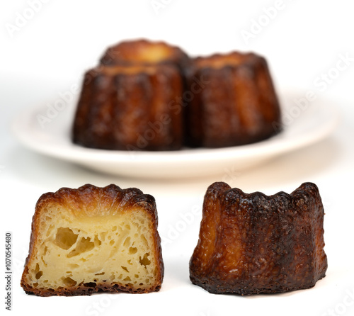 Caneles de bordeaux, traditional French sweet dessert with white table background, High quality photo photo