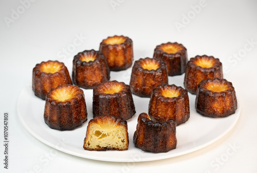 Caneles de bordeaux, traditional French sweet dessert with white table background, High quality photo photo