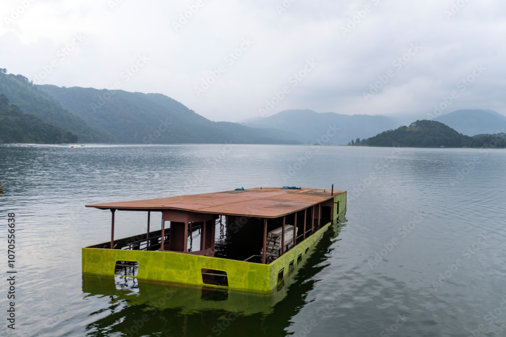 Abandoned Tourist Boat in a lake with beautiful hills in the background 1