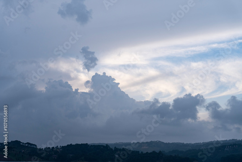 Beautiful moisture bearing clouds formation with hills below 1