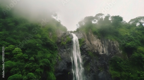 Misty Waterfall in Lush Green Landscape