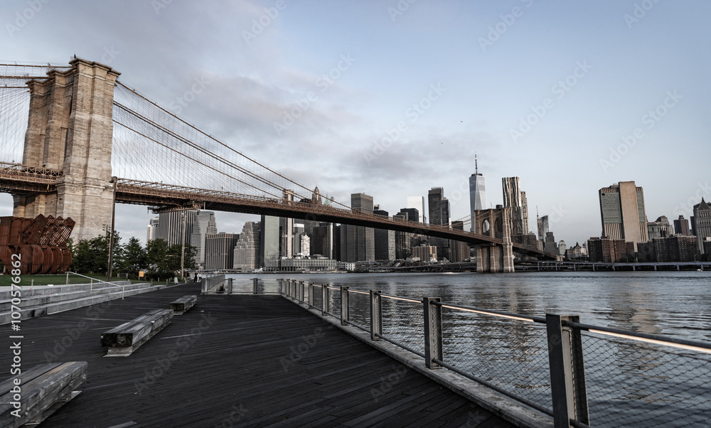 Fototapeta premium Brooklyn bridge in New York. Manhattan cityscape. Amazing scenery of Brooklyn bridge over skyscraper in New York. Architecture of historic bridge in Brooklyn. Way to Manhattan