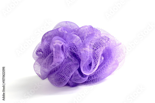 Lilac mesh washcloth lies on a white background. photo