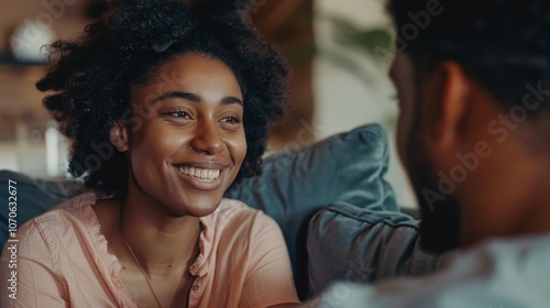 Cheerful woman capturing a fun selfie at home while live streaming in her living room, showcasing a vibrant smile for social media content and fond memories